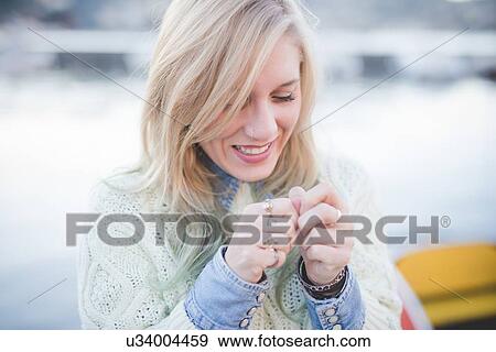 "Young woman fiddling with hands on lakeside, Lake Como, Italy" View Large Photo Image Stock Photo - "Young woman fiddling with hands on lakeside, Lake Como, Italy". Fotosearch
