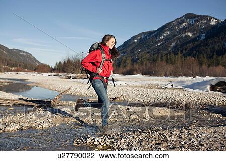 Stock Image - "Young woman hiking in the Alps, Germany". Fotosearch