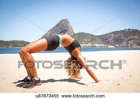 "Young woman in crab position on beach, Rio de Janeiro, Brazil" View Large Photo Image Stock Photography - "Young woman in crab position on beach, Rio de Janeiro, Brazil". Fotosearch