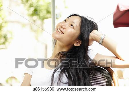 "Young woman looking up at sidewalk cafe, The Bund, Shanghai, China" View Large Photo Image Stock Image - "Young woman looking up at sidewalk cafe, The Bund, Shanghai, China". Fotosearch