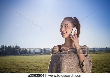Young woman on cell phone View Large Photo Image Stock Image - Young woman on cell phone. Fotosearch