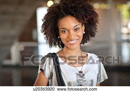 Stock Image - "Young woman smiling, portrait". Fotosearch