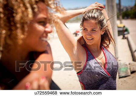 Stock Photo - Young woman stretching arm. Fotosearch