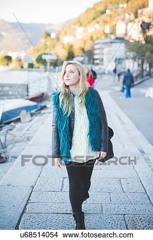 "Young woman strolling at Lake Como, Como, Italy" View Large Photo Image Picture - "Young woman strolling at Lake Como, Como, Italy". Fotosearch