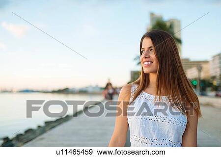 Stock Photo - "Young woman strolling on waterfront, Manila, Philippines". Fotosearch