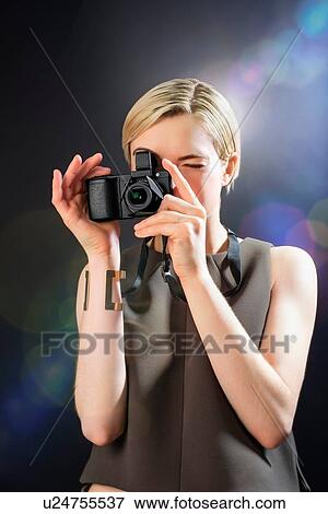 Young woman taking photograph with camera View Large Photo Image Stock Photo - Young woman taking photograph with camera. Fotosearch