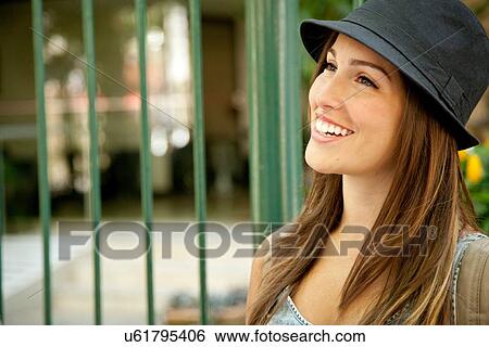 Stock Photograph - "Young woman wearing hat, portrait". Fotosearch