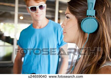 Young woman wearing headphones View Large Photo Image Stock Image - Young woman wearing headphones. Fotosearch