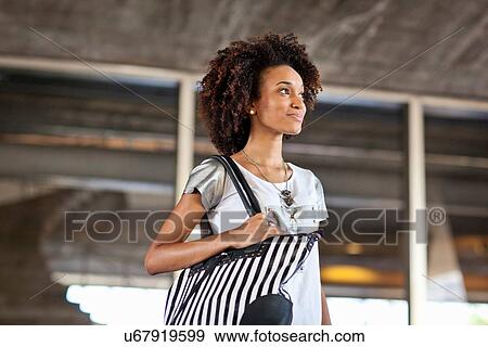 Stock Photo - "Young woman with bag, portrait". Fotosearch