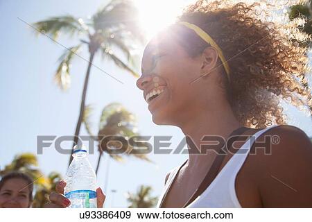 Stock Photo - "Young woman with curly hair, smiling". Fotosearch