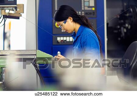 Young woman working in industrial workshop View Large Photo Image Stock Image - Young woman working in industrial workshop. Fotosearch