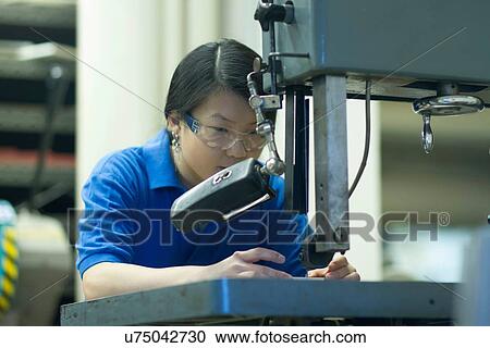 Young woman working in industrial workshop View Large Photo Image Stock Image - Young woman working in industrial workshop. Fotosearch