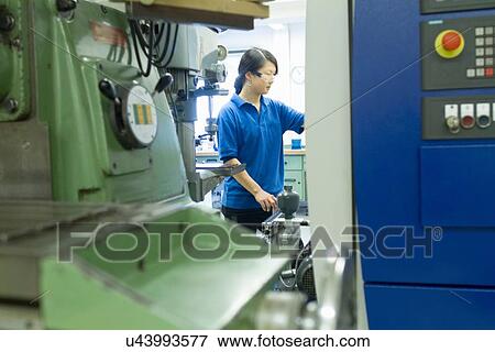 Young woman working in industrial workshop View Large Photo Image Stock Photo - Young woman working in industrial workshop. Fotosearch