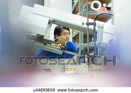 Young woman working in industrial workshop View Large Photo Image Stock Photo - Young woman working in industrial workshop. Fotosearch