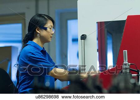 Young woman working in industrial workshop View Large Photo Image Stock Photo - Young woman working in industrial workshop. Fotosearch