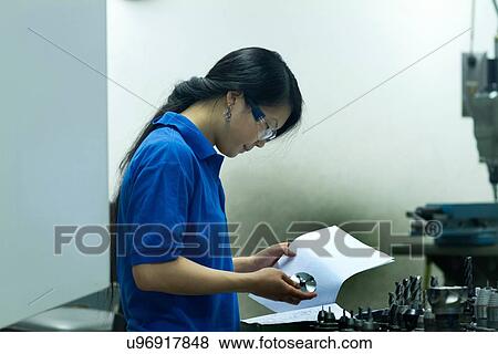 Young woman working in industrial workshop View Large Photo Image Stock Photo - Young woman working in industrial workshop. Fotosearch
