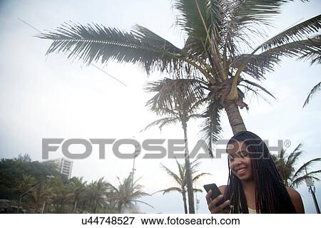 "Young women reading smartphone texts on Ipanema beach, Rio De Janeiro, Brazil" View Large Photo Image Stock Photo - "Young women reading smartphone texts on Ipanema beach, Rio De Janeiro, Brazil". Fotosearch
