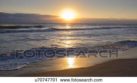 Stock Image - Beach at sunset. Fotosearch
