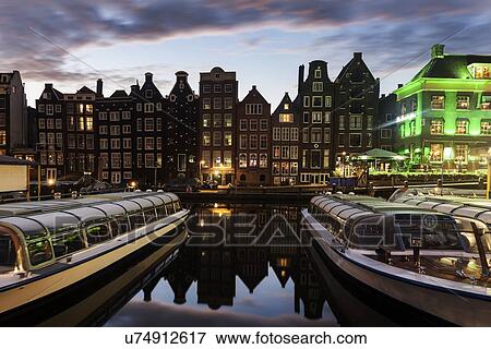 Stock Photo - Boats in canal at sunrise. Fotosearch
