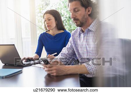 Stock Image - Business people at meeting. Fotosearch