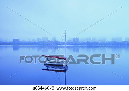 Stock Photo - Charles River with boat shrouded in fog. Fotosearch