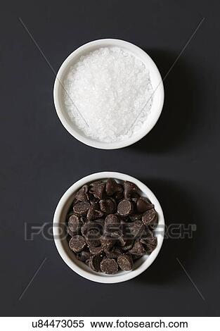 Stock Photography - Chocolate chips and salt in ramekins. Fotosearch