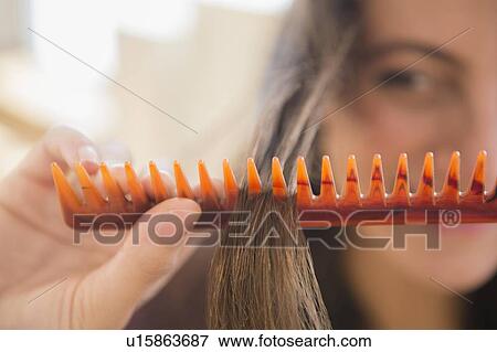 close up of woman brushing her hair View Large Photo Image Stock Photo - close up of woman brushing her hair. Fotosearch