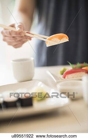 Close-up of woman preparing sushi View Large Photo Image Stock Image - Close-up of woman preparing sushi. Fotosearch