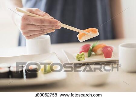 Close-up of woman preparing sushi View Large Photo Image Stock Photo - Close-up of woman preparing sushi. Fotosearch