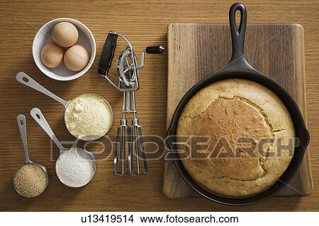 Picture - Cornbread in cast iron pan with ingredients. Fotosearch