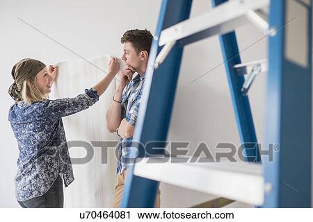 Couple choosing wallpaper for house View Large Photo Image Stock Image - Couple choosing wallpaper for house. Fotosearch