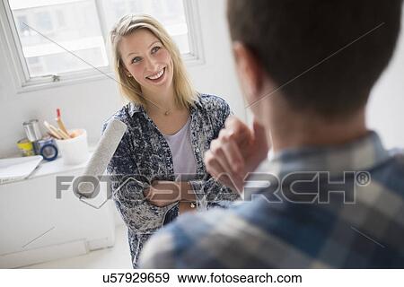 Couple painting room View Large Photo Image Stock Photo - Couple painting room. Fotosearch