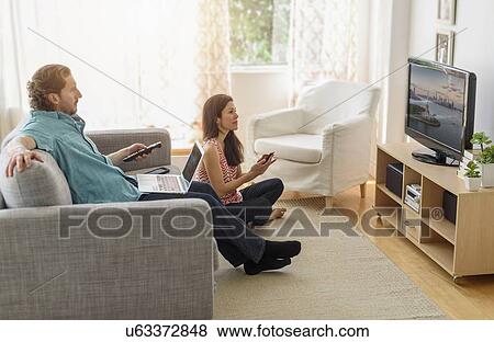 Couple watching tv View Large Photo Image Stock Photo - Couple watching tv . Fotosearch