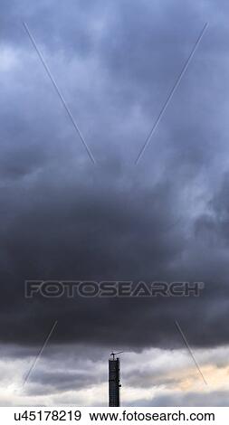 Dramatic sky over skyscraper View Large Photo Image Stock Photo - Dramatic sky over skyscraper. Fotosearch