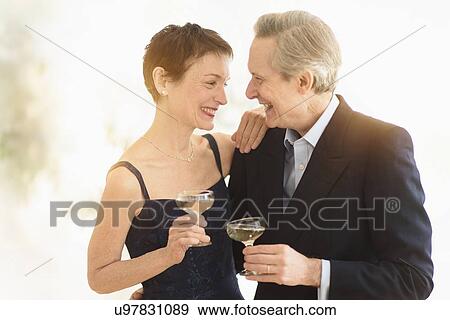 Elegant senior couple celebrating their anniversary with champagne toast View Large Photo Image Stock Photo - Elegant senior couple celebrating their anniversary with champagne toast. Fotosearch