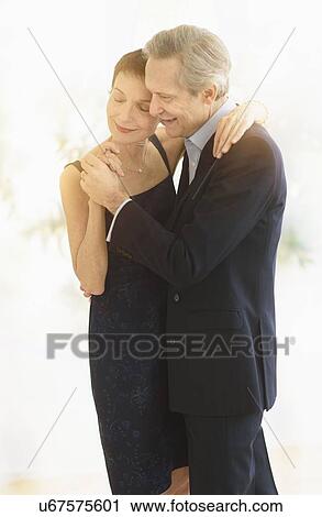 Stock Image - Elegant senior couple dancing while celebrating their anniversary. Fotosearch