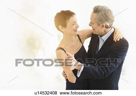 Stock Photo - Elegant senior couple dancing while celebrating their anniversary. Fotosearch