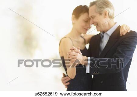 Elegant senior couple dancing while celebrating their anniversary View Large Photo Image Stock Photo - Elegant senior couple dancing while celebrating their anniversary. Fotosearch