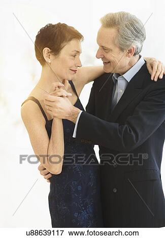 Elegant senior couple dancing while celebrating their anniversary View Large Photo Image Stock Photo - Elegant senior couple dancing while celebrating their anniversary. Fotosearch