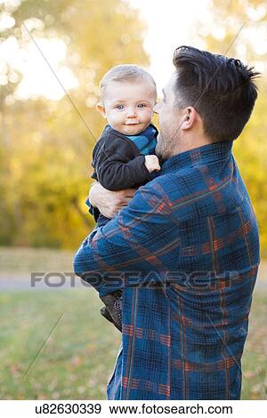 Father holding baby son (6-11 months) View Large Photo Image Stock Photo - Father holding baby son (6-11 months). Fotosearch