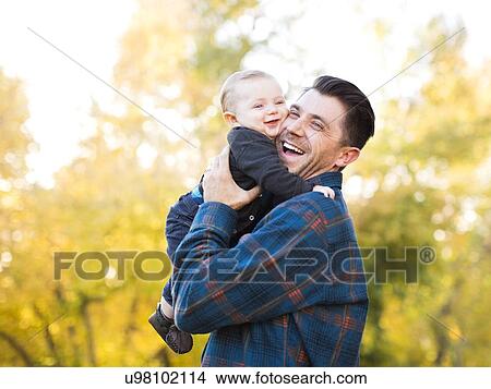 Father hugging baby son (6-11 months) View Large Photo Image Picture - Father hugging baby son (6-11 months). Fotosearch