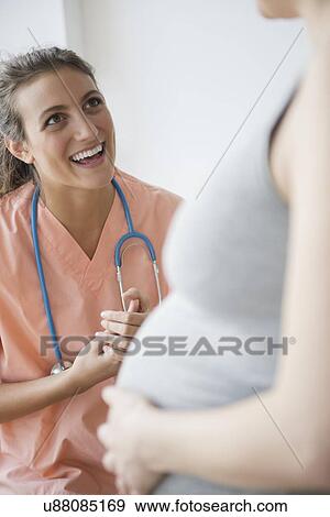 Female doctor and pregnant woman View Large Photo Image Stock Photo - Female doctor and pregnant woman . Fotosearch