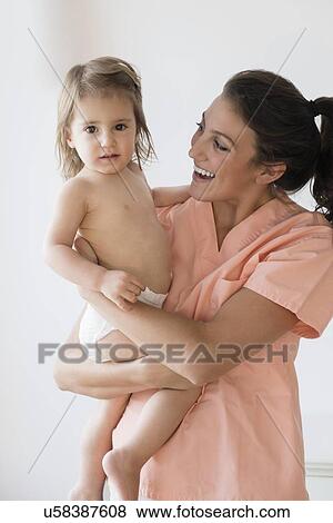 Female doctor holding girl (2-3) View Large Photo Image Stock Photo - Female doctor holding girl (2-3). Fotosearch