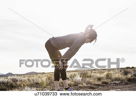 Female runner taking a break View Large Photo Image Stock Image - Female runner taking a break. Fotosearch