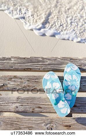 Flip flops on pier by sea View Large Photo Image Stock Photograph - Flip flops on pier by sea. Fotosearch