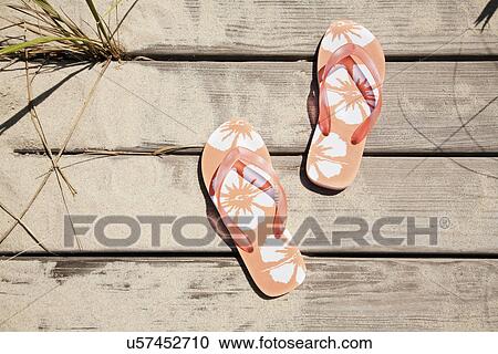 Stock Image - Flip flops on pier. Fotosearch