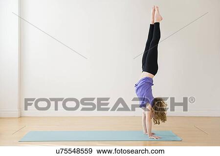 Girl (10-11) doing handstand View Large Photo Image Stock Photo - Girl (10-11) doing handstand. Fotosearch