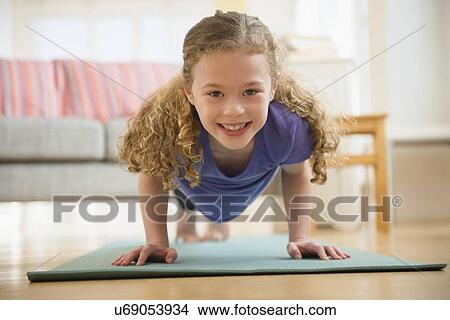 Picture - Girl (10-11) exercising yoga. Fotosearch