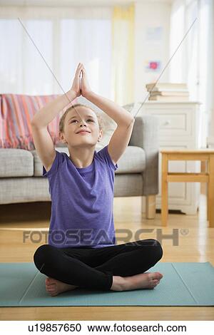 Stock Image - Girl (10-11) exercising yoga. Fotosearch