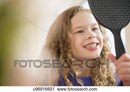 Girl (10-11) smiling to mirror View Large Photo Image Stock Image - Girl (10-11) smiling to mirror. Fotosearch